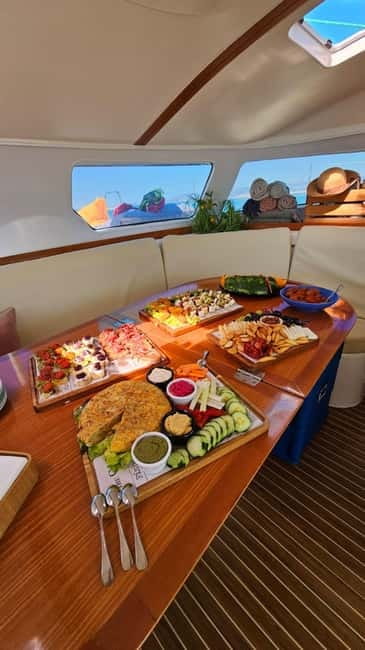 From Palma: Luxury Catamaran Group Tour with Tapas & Drinks - Bay Time in Turquoise Water: Swimming, Snorkeling, SUP, and Floats