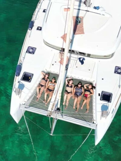 Dinner aboard a private catamaran with snorkeling and paddle surfing